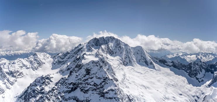 aerial landscape, from a glider plane, of Disgrazia peak and range, shot from north in bright late spring light, Sondrio, Italy