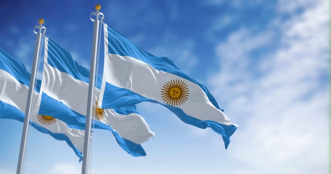 Three Argentine flags fluttering in the wind on a sunny day. Three equal blue and white horizontal bands with the Sun of May in the center. 3d illustration render. Selective focus