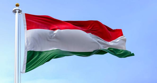 The national flag of Hungary fluttering in the wind on a clear day. Horizontal striped flag of red, white and green. 3d illustration render. Fluttering fabric