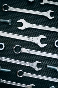 Set of chrome wrenches on steel surface. Mechanic tools for maintenance. Hardware tools to fix. Technical tools background