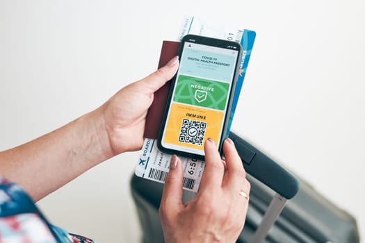 Digital covid certificate. Covid negative rapid digital test pass. Woman passenger holding digital medical pass on her mobile phone, passport and airplane ticket. Traveler showing digital covid test result as medical pass for travel during covid-19 pandemic