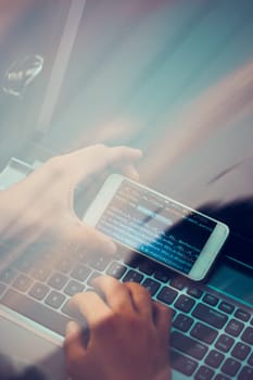 Hacker using computer, smartphone and coding to steal password and private data remotely from car. Screen displaying program code, website development, application building, password and private data