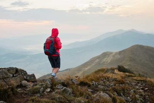 Hiking in mountains. Mountain landscape. Scenic view of mountain peaks, slopes, hills and valleys covered with grass and trees. Panoramic view. Natural scenery. Beautiful background
