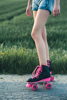 Teenage girl having fun rollerskating, jumping, spending time on summer day