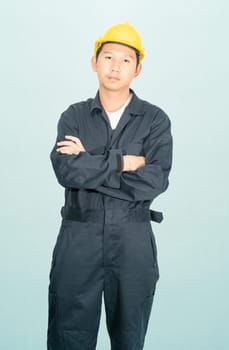 Young man in coveralls helmet hardhat isolated on blue background