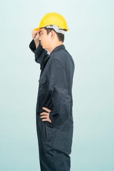 Young man in coveralls helmet hardhat isolated on blue background