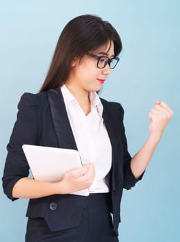 Young women standing in suit holding her digital tablet computor with finger pointing up