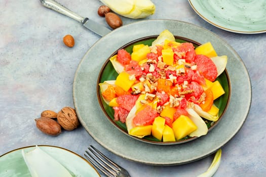 Freshly vitamin salad of grapefruit, mango and chicory. Copy space