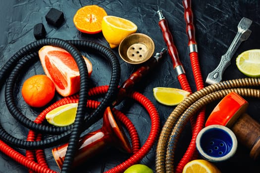 Smoking relax hookah with tobacco. The pleasure of smoking. Oriental shisha and fruits.