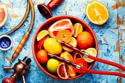 Smoking relax hookah with tobacco. The pleasure of smoking. Oriental shisha and fruits.