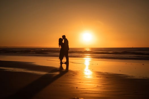 A couple stands alone on a deserted beach, their arms wrapped around each other as the sun sets in a blaze of warm, golden light. The scene is peaceful and serene, with the quiet sound of waves lapping against the shore. The couple is in a state of harmony and love, lost in the beauty of the moment. This scene can evoke feelings of peace, love, and contentment. (generative AI)