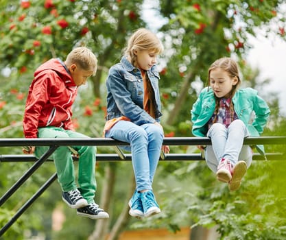 Friendly kids spending leisure outdoors