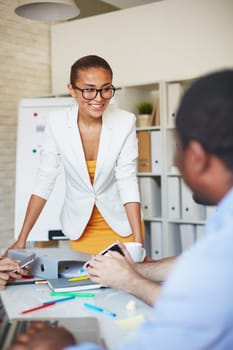 Smiling businesswoman listening to colleague at meeting