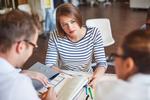 Serious businesswoman listening to colleague