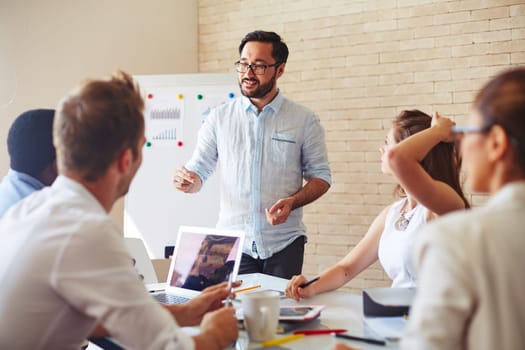 Modern businessman explaining his ideas to colleagues at seminar