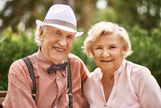 Cheerful seniors looking at camera with smiles outdoors
