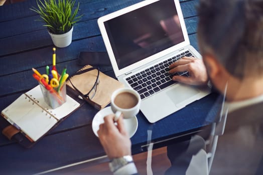 Businessman typing on laptop at workplace