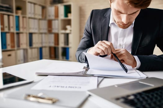 Businessman working with papers in office