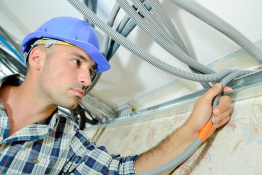 Skilled electrician wiring a house