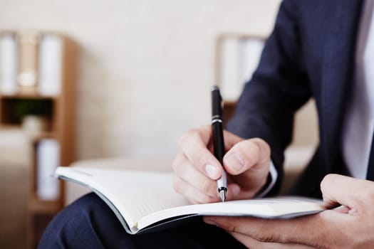 Male employee making notes in notepad