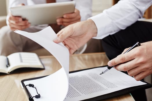 Male employee with pen pointing at contract