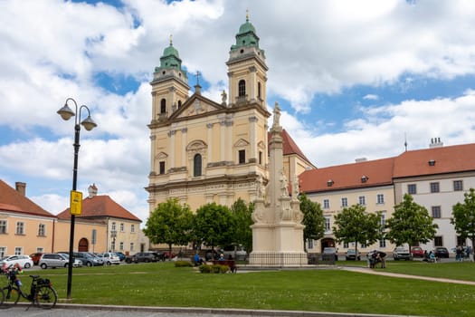 VALTICE, CZECH REPUBLIC - MAY 7th 2023: Baroque church of the Assumption of the Virgin Mary at Freedom Square at sunny summer day, UNESCO world heritage, popular travel destination