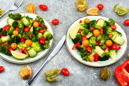 Bright dietary vegetable salad of cabbage, herbs and physalis. Healthy eating