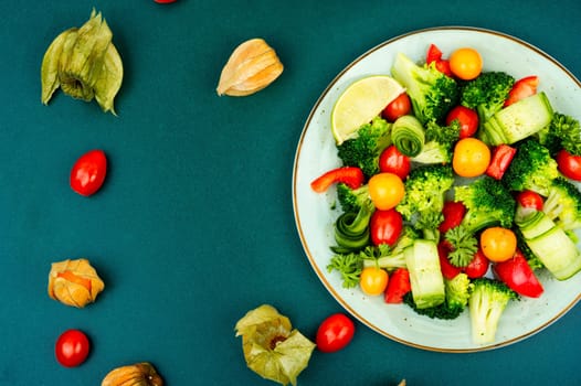 Bright dietary vegetable salad of cabbage, herbs and physalis. Healthy eating