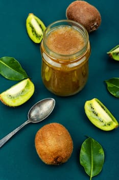 Fresh natural kiwi jam in a glass jar. Top view