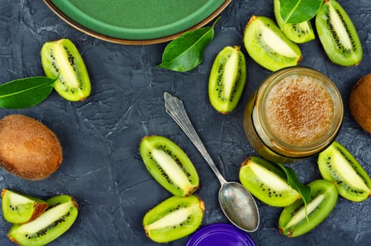 Fresh natural kiwi jam in a glass jar. Top view