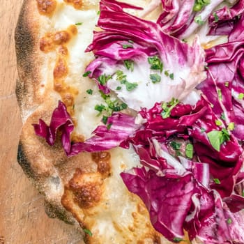 Neapolitan pizza with mozzarella and radicchio. Classic Italian recipe.