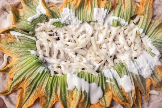 Closeup of raw pizza to bake, with mozzarella and zucchini. Vegetarian food.