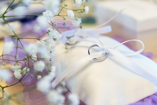 Wedding ring on a pillow as wedding symbol