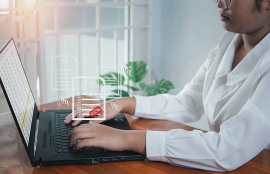 Business woman using a computer to complete Individual income tax return form online for tax payment. financial research, report. Calculation tax return.