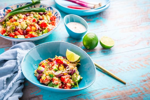 Mexican quinoa black bean salad with fresh tomatoes, cucumbers, onion and cilantro