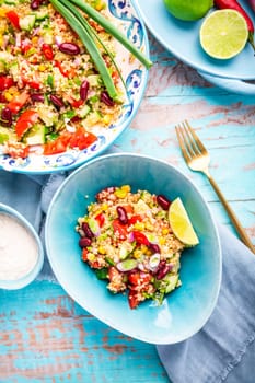 Mexican quinoa black bean salad with fresh tomatoes, cucumbers, onion and cilantro