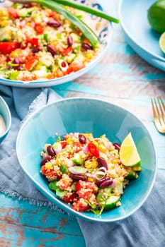 Mexican quinoa black bean salad with fresh tomatoes, cucumbers, onion and cilantro