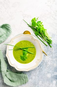 Healthy green soup with fresh spring plants, herbs, winter purslane, chives and ramson