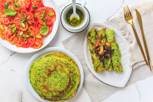 Savory wirld garlic (ramson, bear leek, Allium ursinum) pancakes with tomato salad