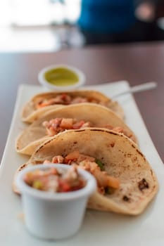 Close up of mexican chicken tacos, chicken tacos with salsa served on the table, tacos served on the table