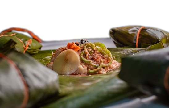 Raw ingredients for the preparation of the traditional Nacatamal, close-up of the raw ingredients of the Nicaraguan nacatamal. Nacatamal ingredients on banana leaves