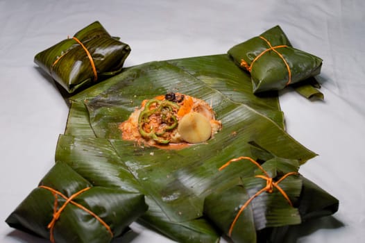 Top View of raw ingredients of the Nicaraguan nacatamal on banana leaves. Raw ingredients for the preparation of the traditional Nacatamal, Nacatamal ingredients on banana leaves