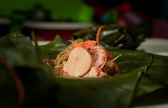 Nacatamal ingredients on banana leaves, Closeup of raw ingredients for the elaboration of a Nicaraguan nacatamal. Preparation of the traditional Nacatamal on banana leaves