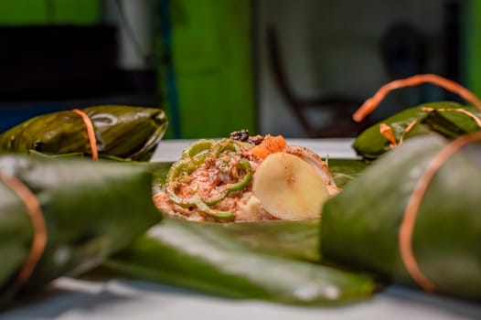 Preparation of the traditional Nacatamal, closeup of raw ingredients for the elaboration of a Nicaraguan nacatamal. Nacatamal ingredients on banana leaves