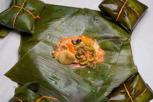 Top View of raw ingredients of the Nicaraguan nacatamal on banana leaves. Raw ingredients for the preparation of the traditional Nacatamal, Nacatamal ingredients on banana leaves