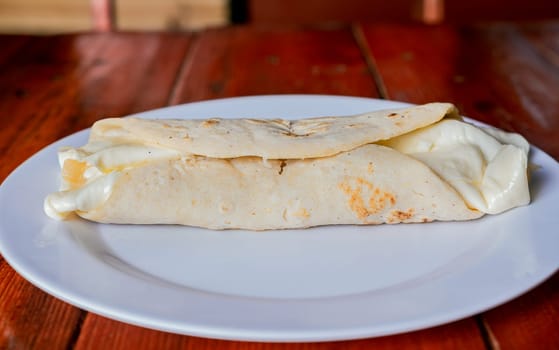 Traditional cheese dish with pickled onion and cream. Traditional Cheese with Pickled Onion,  Concept of typical foods of latin america