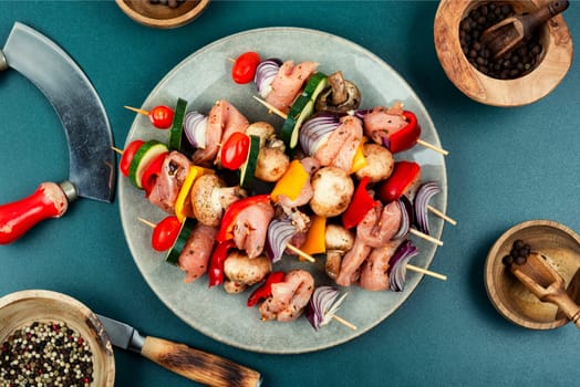 Fresh skewers with pieces of raw meat and vegetables marinated in herbs. Raw shashlik and vegetables