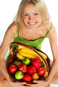 woman holds a basket of fruit on a white background