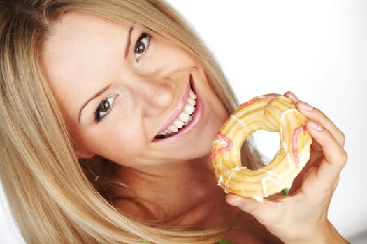 woman eating a cake on a white background