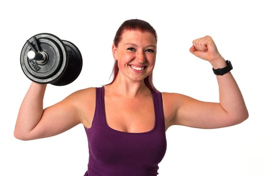 Young beautiful red-haired fitness female excersises with dumbbell, isolated on white background